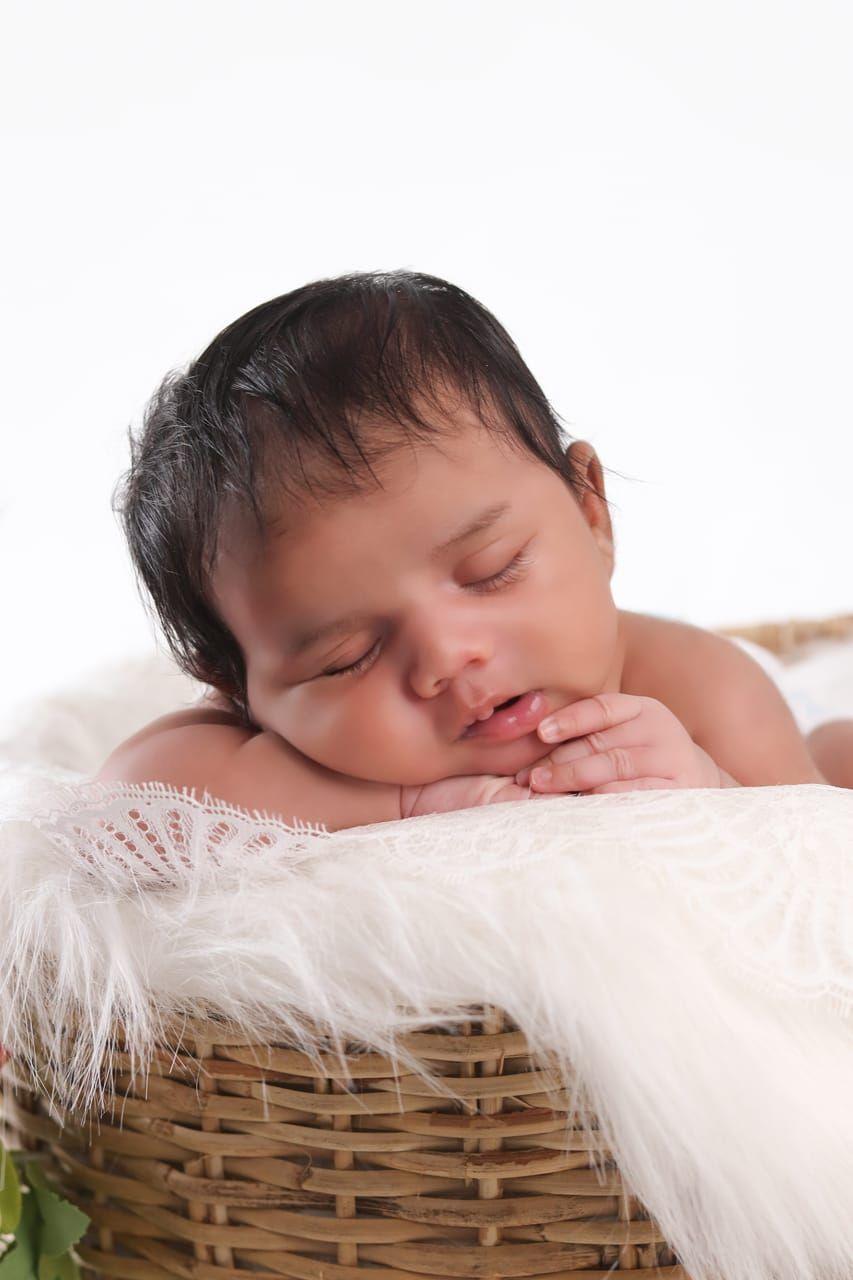 Peaceful sleeping newborn wrapped in soft fabric